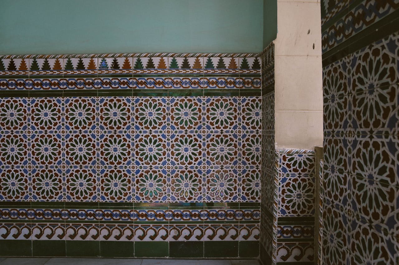 gallery-1 A detailed view of colorful geometric patterns on Islamic mosaic tile wall.