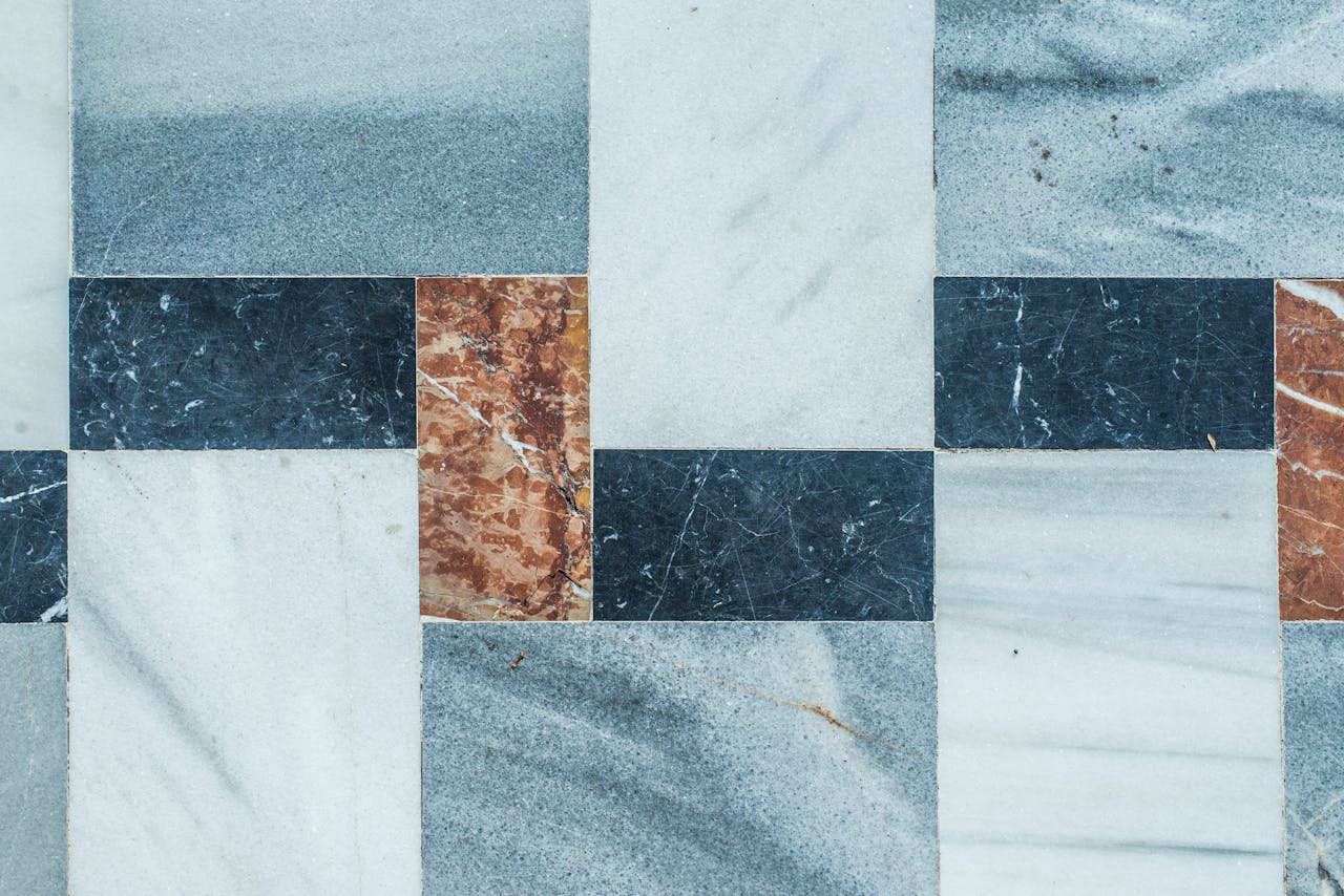 Close-up of a geometric marble tile pattern with natural texture colors.